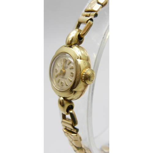 7141 - A 14ct gold cased lady's Rado wristwatch on a plated strap, 16mm case including crown