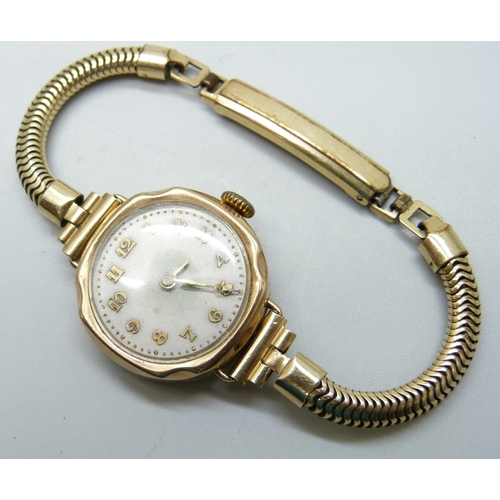 7143 - A 9ct gold cased lady's wristwatch, back case 2g, 25mm including crown, on a plated strap