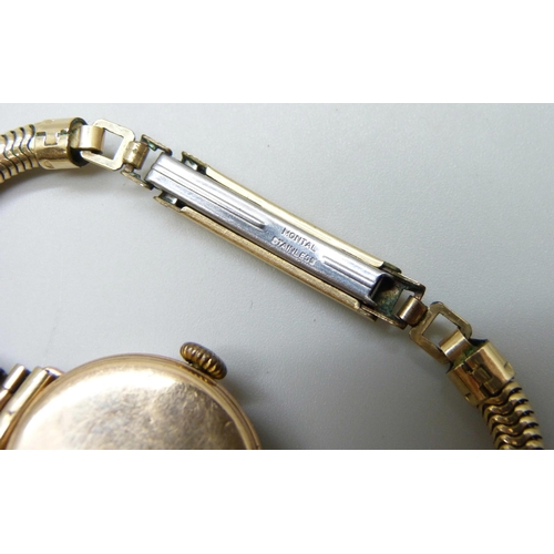 7143 - A 9ct gold cased lady's wristwatch, back case 2g, 25mm including crown, on a plated strap