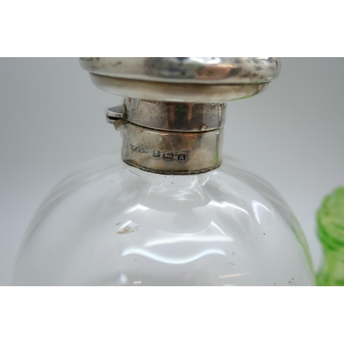 7224 - A silver topped glass scent bottle with monogram, with glass stopper, and one other green glass scen... 