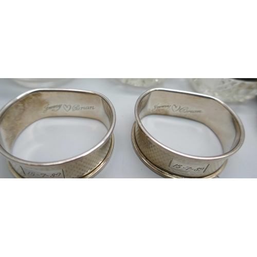 7250 - Two silver napkin rings, 22g, two silver rimmed salts, an atomiser with silver collar, and a beadwor... 