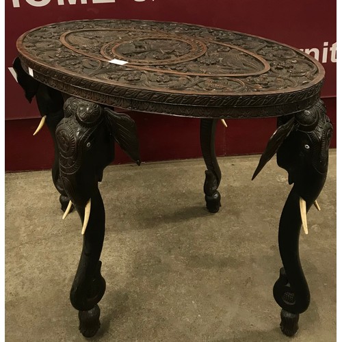 133 - An early 20th Century Indian carved hardwood oval occasional table. With non-transferable Standard I... 