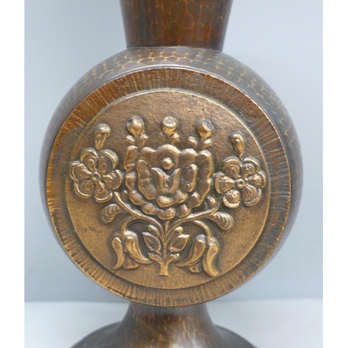 2021 - An Arts and Crafts hammered copper vase with flower detail, 29cm