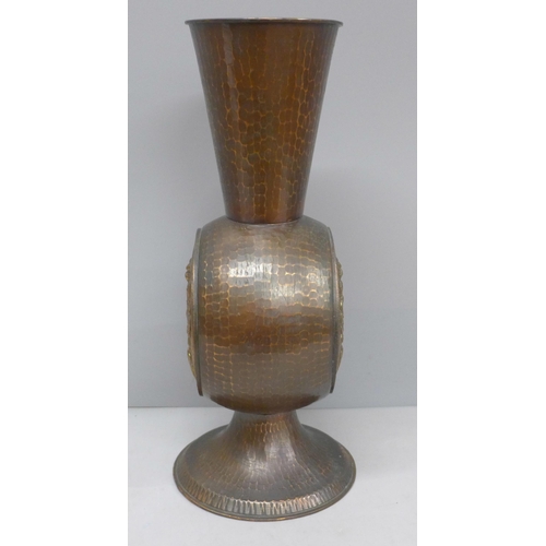 2021 - An Arts and Crafts hammered copper vase with flower detail, 29cm