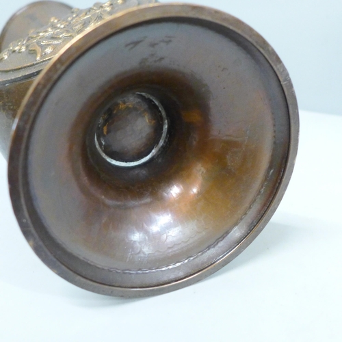 2021 - An Arts and Crafts hammered copper vase with flower detail, 29cm