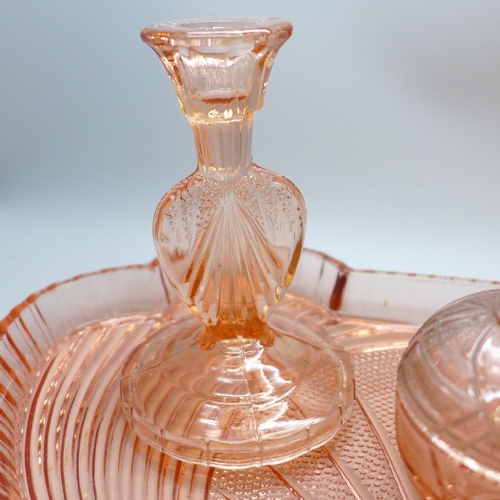 2057 - An Art Deco peach glass dressing table tray, a pair of candlesticks and lidded pot, tray a/f