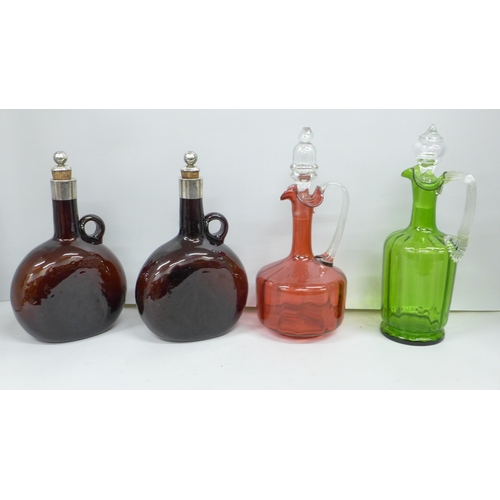 2079 - A pair of c1900 glass decanters with plated tops, a cranberry glass decanter and a green glass decan... 