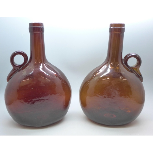 2083 - Two Victorian dark amber glass flagon decanters