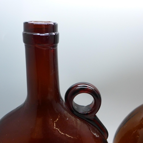 2083 - Two Victorian dark amber glass flagon decanters