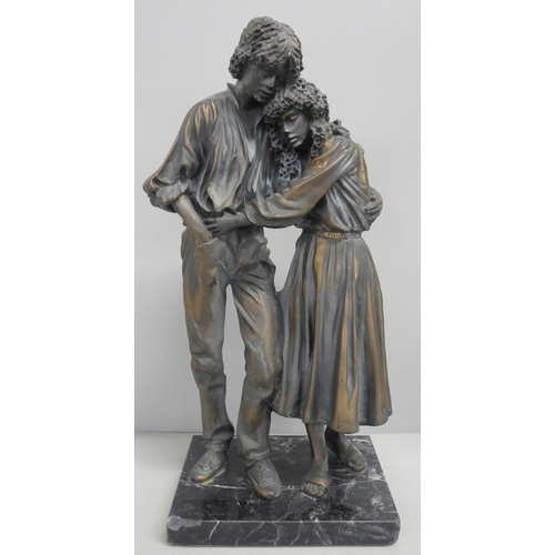 2148 - A resin bronze effect figure of a couple embracing, raised on a marble square base. AF