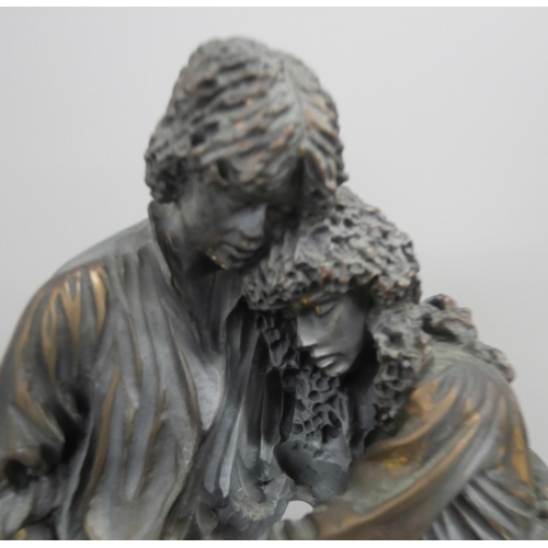 2148 - A resin bronze effect figure of a couple embracing, raised on a marble square base. AF