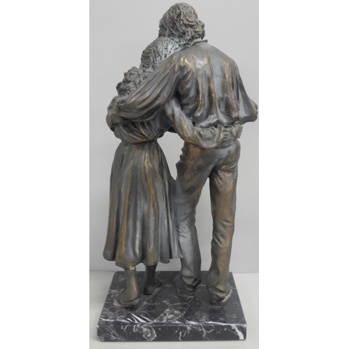 2148 - A resin bronze effect figure of a couple embracing, raised on a marble square base. AF