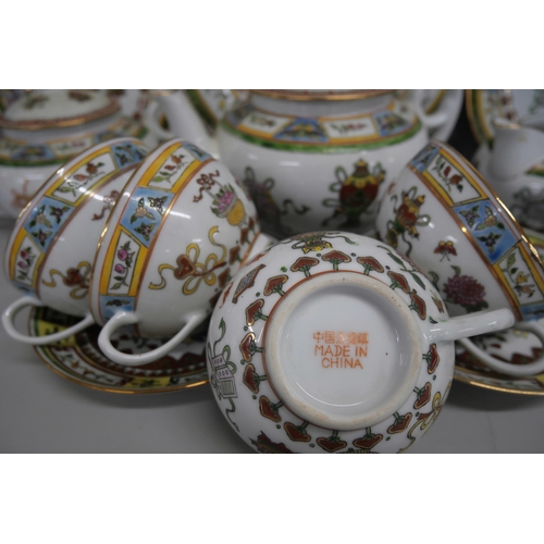 2161 - A Chinese porcelain tea service comprising of teapot, jug, teacups, saucers, small plates and one la... 