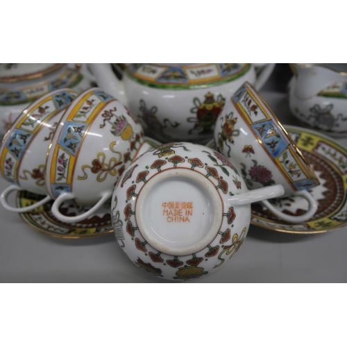 2161 - A Chinese porcelain tea service comprising of teapot, jug, teacups, saucers, small plates and one la... 