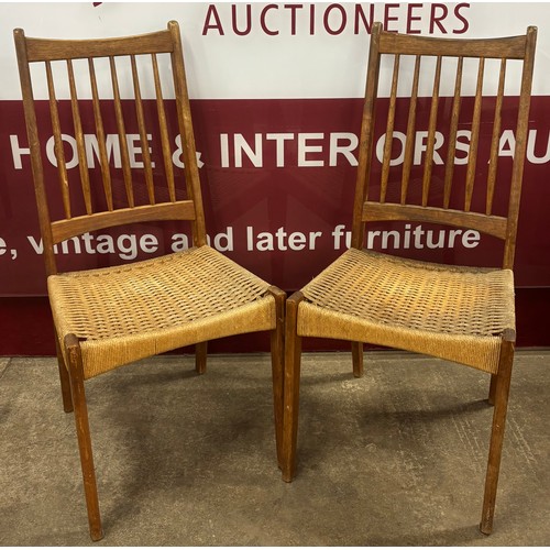 62 - A pair of Danish Mogens Kold teak and paper cord seated dining chairs, designed by Arne Hovmand-Olse... 