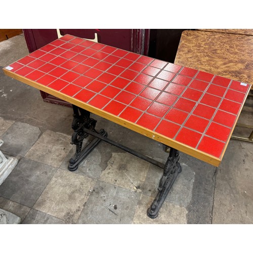 296 - A cast iron and red tiled topped pub table