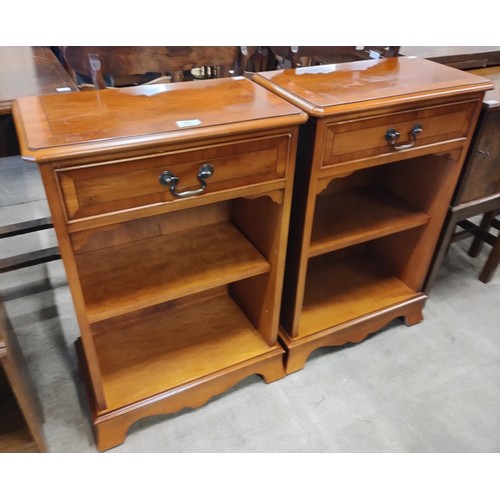 210 - A pair of Regency style yew wood single drawer open bookcases