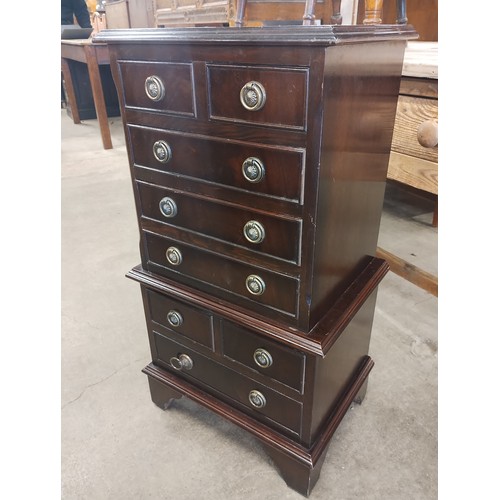 215 - A small George III style inlaid mahogany chest on chest