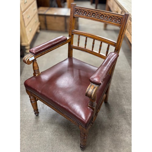 180 - A Victorian Aesthetic Movement oak and red vinyl desk chair