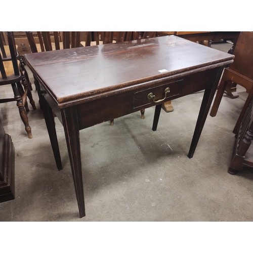 219 - A George III mahogany rectangular fold over tea table