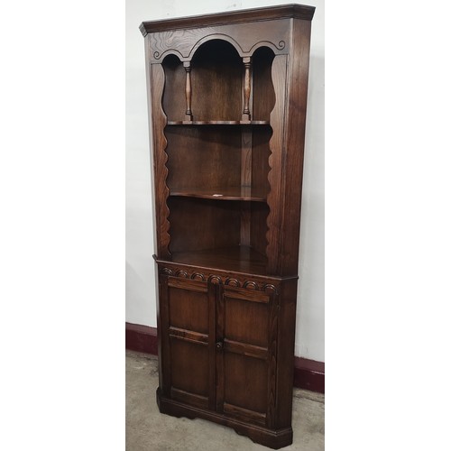 225 - A 17th Century style carved oak corner cabinet