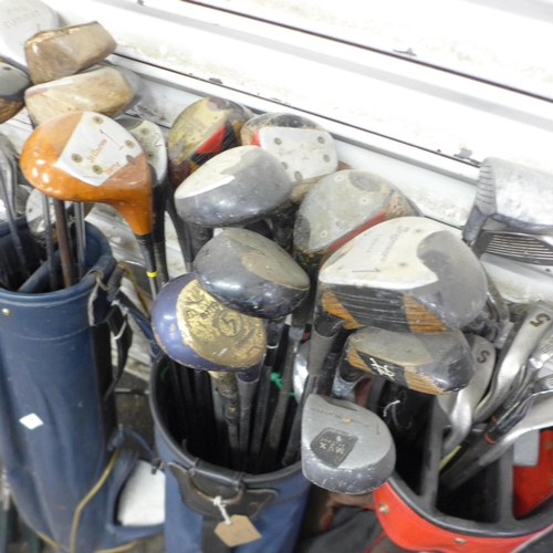 5198 - A large quantity of assorted golf equipment including 3 bags and a quantity of golf clubs including ... 