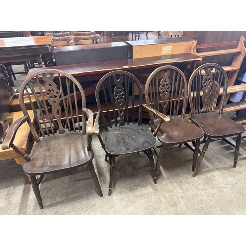 283 - A set of four early 20th Century elm and beech wheelback kitchen chairs