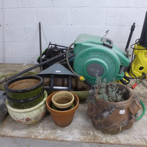 5207 - A bird feeder with feeders, bird table, a Hozelock auto reel and hose and various plant pots