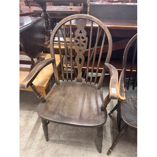 283 - A set of four early 20th Century elm and beech wheelback kitchen chairs