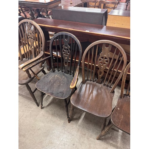 283 - A set of four early 20th Century elm and beech wheelback kitchen chairs