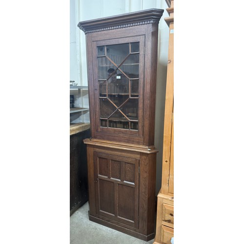 290 - A George III style oak freestanding corner cupboard