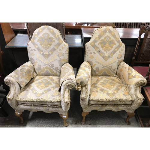 275 - A pair of early 20th Century Queen Anne style walnut and fabric upholstered armchairs