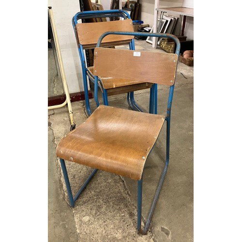 301 - A set of four mid 20th Century tubular steel and ply seated stacking chairs