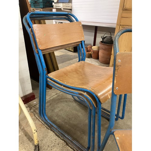 301 - A set of four mid 20th Century tubular steel and ply seated stacking chairs