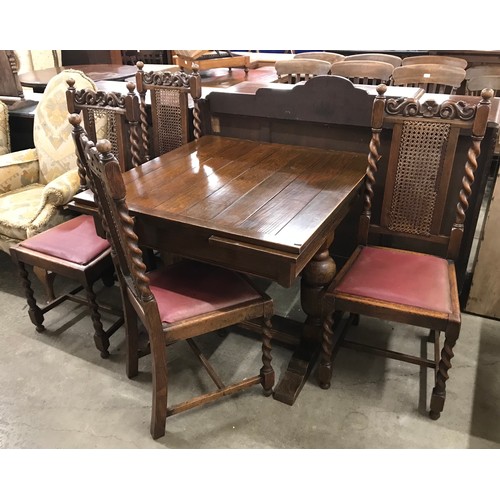 276 - An early 20th Century oak draw leaf table and four chairs