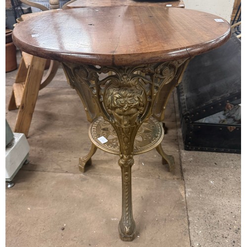 294 - A Victorian style mahogany and cast iron based pub table