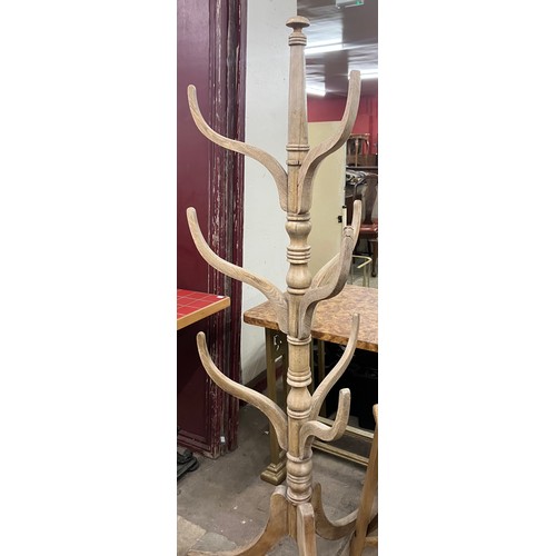 317 - An oak shop display hat stand and a set of ladders