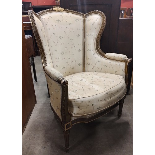 229 - A French Louis XV style gilt wood and fabric upholstered armchair