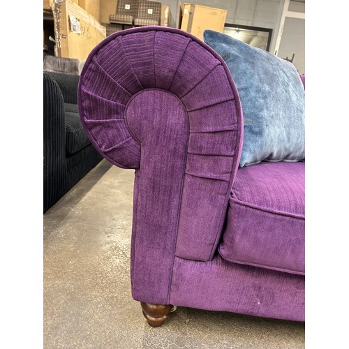 3153 - A violet upholstered button back three seater sofa and footstool (transit marked)