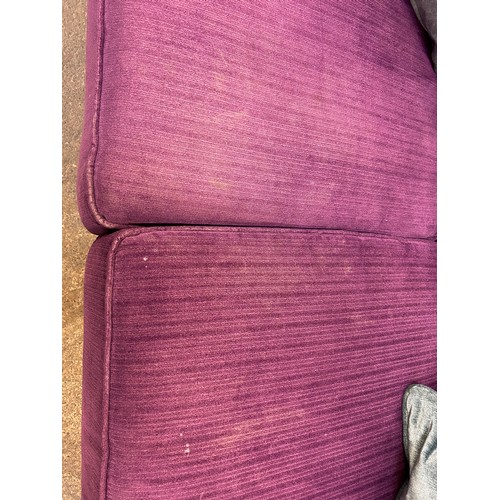 3153 - A violet upholstered button back three seater sofa and footstool (transit marked)