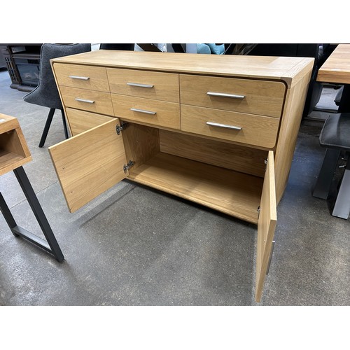 3181 - An oak 6 drawer, 3 door sideboard