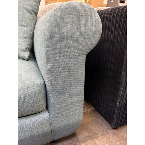 3150 - A turquoise upholstered three seater sofa (foot requires attention, missing back cushions)