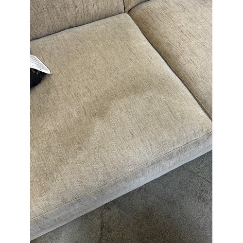 3295 - An oatmeal upholstered three seater sofa (marked cushions)