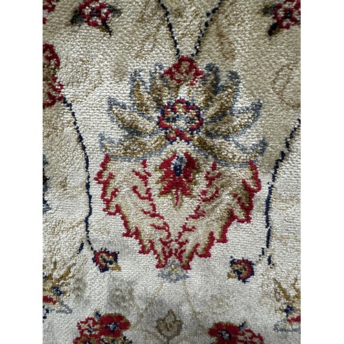 3264 - An Ivory ground full pile cashmere rug with an all over floral pattern