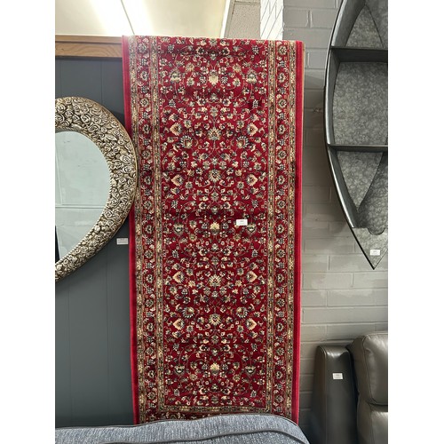 3081 - A red ground full pile cashmere runner with an all over floral design