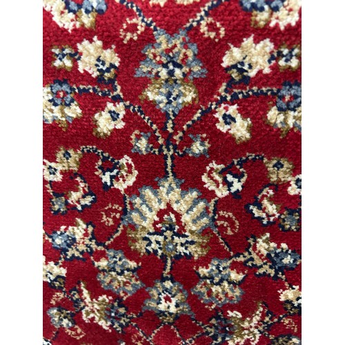 3081 - A red ground full pile cashmere runner with an all over floral design