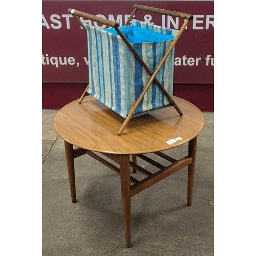 28 - A teak circular coffee table and a bamboo sewing basket