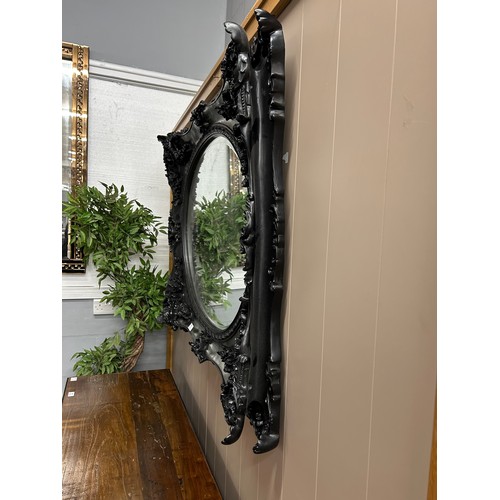 3020 - A black carved frame wall mirror