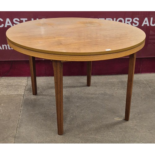 61 - A teak circular extending dining table