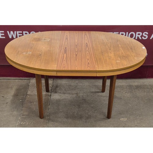 61 - A teak circular extending dining table